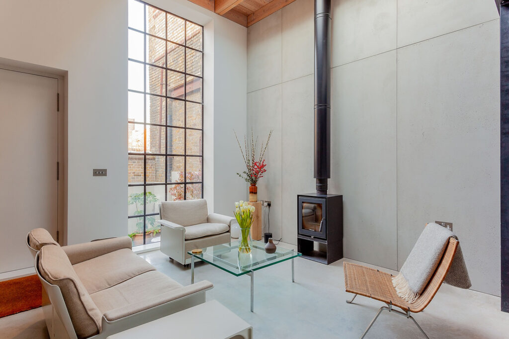 Old gin distillery converted into a home, concrete walls, large crittall windows, statement log burner