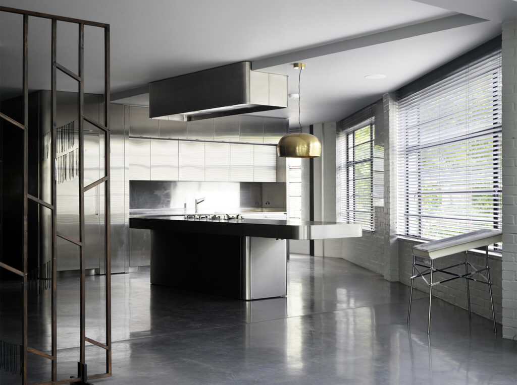 Warehouse conversion with stainless steel kitchen, minimalistic.