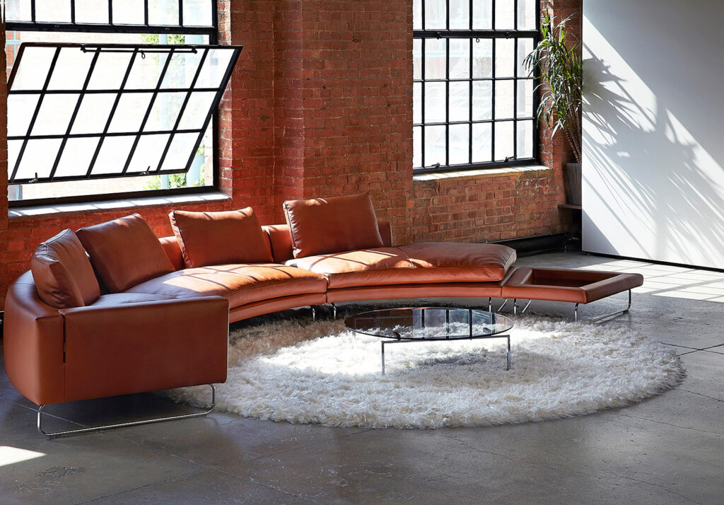 Exposed brick, crittall windows, concrete floors, stylish curved sofa